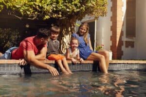 Family relaxing by the pool