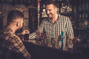 Man chatting with a bartender in a pub